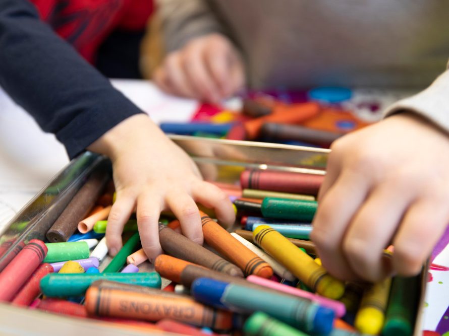 Childrens hands with crayons